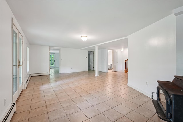 25 Cascade Lake Rd, Warwick, NY 10990 - unfurnished room featuring baseboard heating, light tile patterned flooring, stairway, and a wood stove