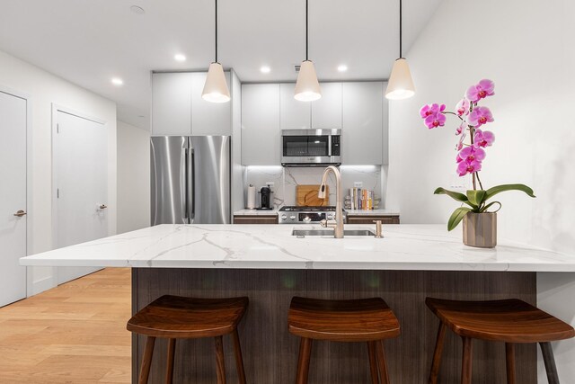334 22nd St Unit 2B, Brooklyn, NY 11215 - kitchen featuring stainless steel appliances, modern cabinets, a breakfast bar, white cabinetry, and recessed lighting
