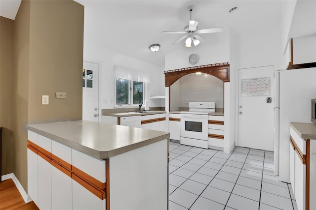 127 Continental Rd, Cornwall, NY 12518 - kitchen featuring white appliances, a peninsula, a ceiling fan, white cabinets, and vaulted ceiling