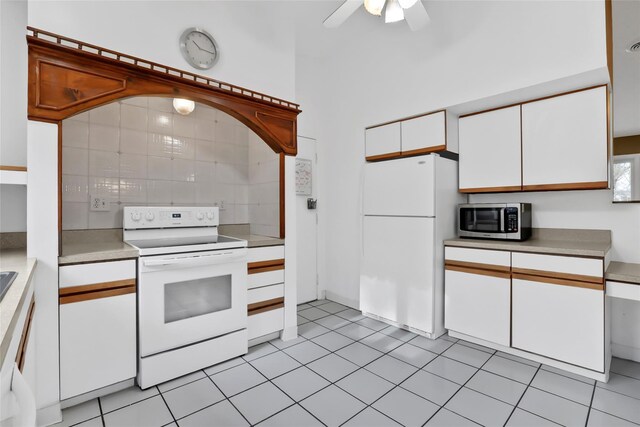 127 Continental Rd, Cornwall, NY 12518 - kitchen featuring white appliances, light countertops, white cabinetry, ceiling fan, and light tile patterned flooring