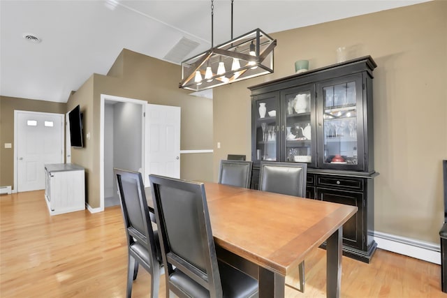 127 Continental Rd, Cornwall, NY 12518 - dining room with a baseboard heating unit, a chandelier, and light wood-style flooring