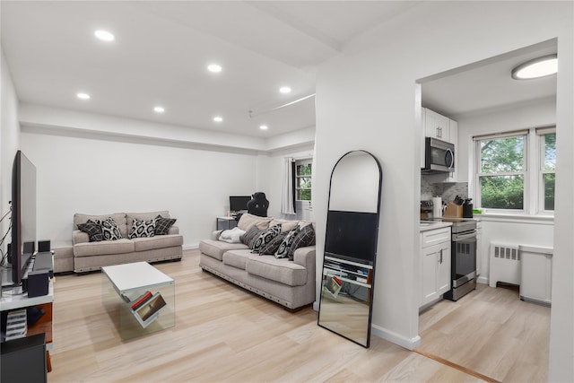140 N Broadway Unit It9, Irvington, NY 10533 - living area featuring radiator heating unit, light wood-style flooring, and recessed lighting