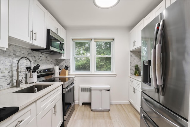 140 N Broadway Unit It9, Irvington, NY 10533 - kitchen with stainless steel appliances, light countertops, radiator, and backsplash