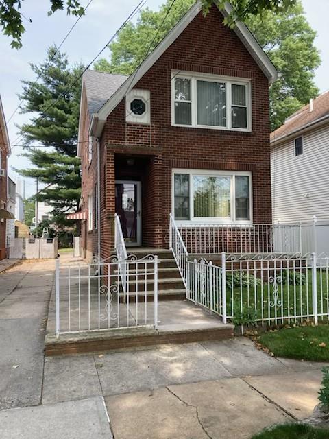 3183 Waterbury Ave, Bronx, NY 10465 - view of front of house with brick siding and a fenced front yard