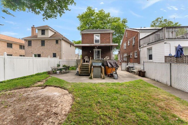 3183 Waterbury Ave, Bronx, NY 10465 - rear view of property with brick siding, a patio, and a fenced backyard