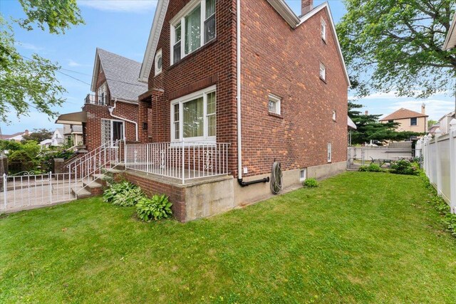 3183 Waterbury Ave, Bronx, NY 10465 - view of home's exterior with brick siding, a fenced backyard, and a chimney