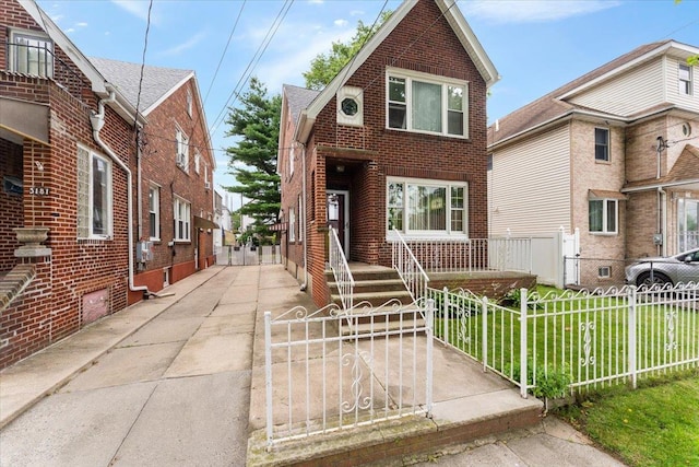 3183 Waterbury Ave, Bronx, NY 10465 - view of front facade featuring brick siding and a fenced front yard