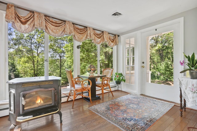 42 N Healy Ave, Hartsdale, NY 10530 - sunroom with a wood stove, hardwood / wood-style floors, a deck, and a baseboard heating unit
