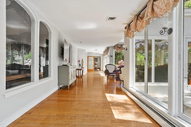 42 N Healy Ave, Hartsdale, NY 10530 - hall featuring a baseboard heating unit and light wood-style flooring