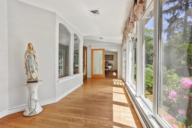 42 N Healy Ave, Hartsdale, NY 10530 - hallway with plenty of natural light, light wood finished floors, and a baseboard radiator