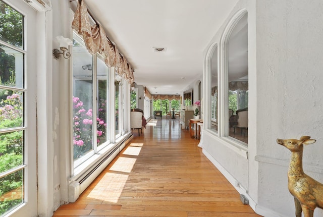 42 N Healy Ave, Hartsdale, NY 10530 - corridor featuring baseboard heating, light wood finished floors, and plenty of natural light