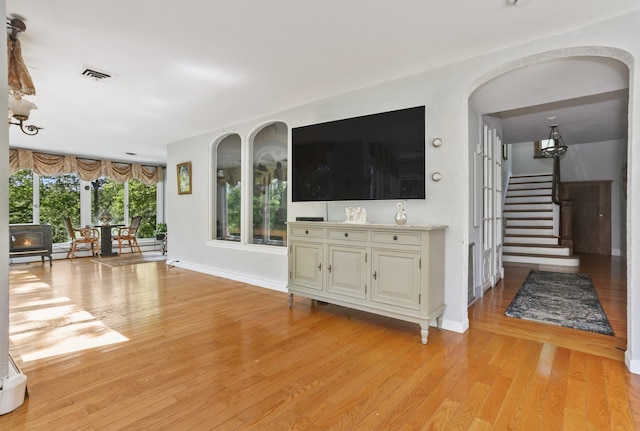 42 N Healy Ave, Hartsdale, NY 10530 - unfurnished living room with light wood-style flooring and stairs