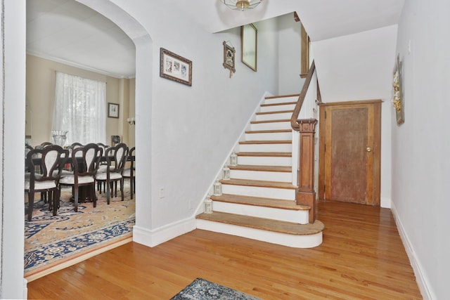 42 N Healy Ave, Hartsdale, NY 10530 - stairway featuring wood finished floors, arched walkways, and crown molding