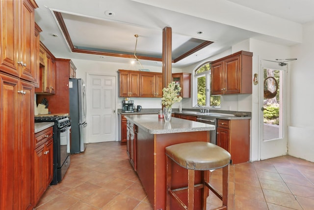 42 N Healy Ave, Hartsdale, NY 10530 - kitchen with appliances with stainless steel finishes, a raised ceiling, a center island, light tile patterned flooring, and brown cabinetry