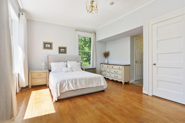 42 N Healy Ave, Hartsdale, NY 10530 - bedroom featuring wood finished floors and a chandelier