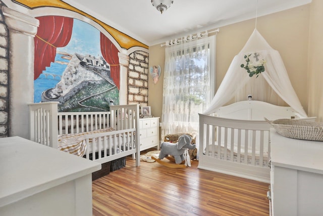 42 N Healy Ave, Hartsdale, NY 10530 - bedroom featuring wood finished floors, multiple windows, and a crib