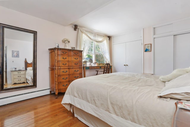 42 N Healy Ave, Hartsdale, NY 10530 - bedroom with multiple closets, light wood-style flooring, and a baseboard heating unit