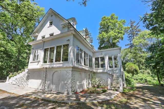 42 N Healy Ave, Hartsdale, NY 10530 - view of front facade with a sunroom and stairs