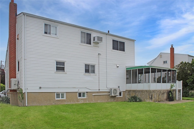 10 Marilyn Ct, West Babylon, NY 11704 - rear view of house with a sunroom, a lawn, a wall unit AC, and a chimney