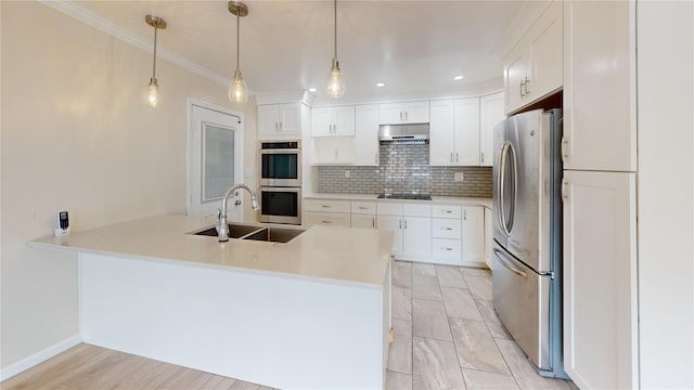 10 Marilyn Ct, West Babylon, NY 11704 - kitchen featuring appliances with stainless steel finishes, a peninsula, backsplash, white cabinets, and crown molding