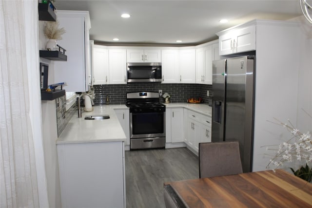 10 Marilyn Ct, West Babylon, NY 11704 - kitchen with appliances with stainless steel finishes, open shelves, dark wood-style floors, tasteful backsplash, and light countertops