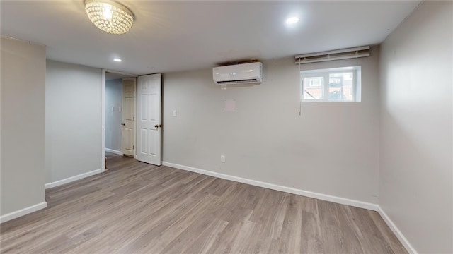 10 Marilyn Ct, West Babylon, NY 11704 - below grade area with a wall unit AC, light wood-style floors, and recessed lighting