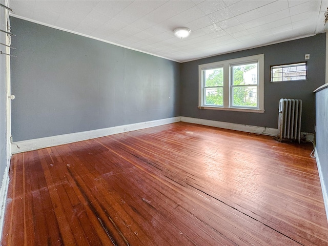 19-23 23rd Rd, Astoria, NY 11105 - empty room with radiator heating unit, ornamental molding, and hardwood / wood-style flooring
