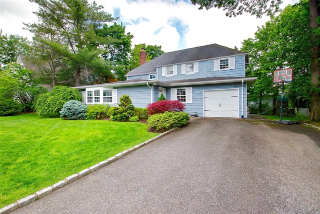 20 Primrose Ln, East Hills, NY 11577 - traditional-style home with driveway, a chimney, a front yard, and a garage