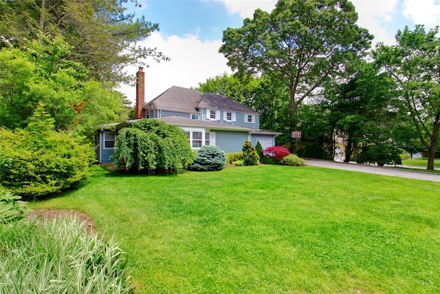 20 Primrose Ln, East Hills, NY 11577 - view of front of property with a chimney, a front lawn, and driveway