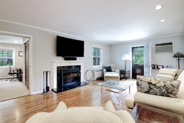 20 Primrose Ln, East Hills, NY 11577 - living room with radiator heating unit, crown molding, recessed lighting, light wood-type flooring, and an AC wall unit