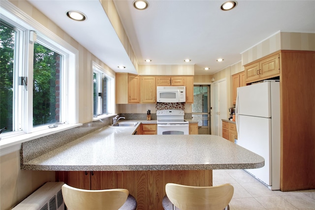 20 Primrose Ln, East Hills, NY 11577 - kitchen with white appliances, light brown cabinets, a peninsula, healthy amount of natural light, and recessed lighting