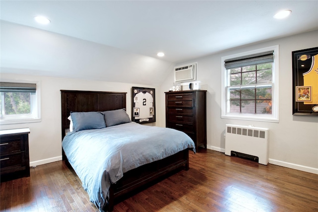 20 Primrose Ln, East Hills, NY 11577 - bedroom with radiator, multiple windows, dark wood-type flooring, lofted ceiling, and a wall mounted AC