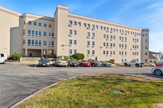 280 Lowndes Ave Unit 208, Huntington Station, NY 11746 - view of building exterior featuring uncovered parking