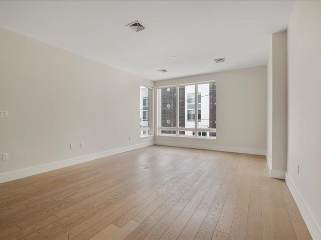 160 Bch 5th St, Far Rockaway, NY 11691 - spare room featuring light wood-style flooring and baseboards
