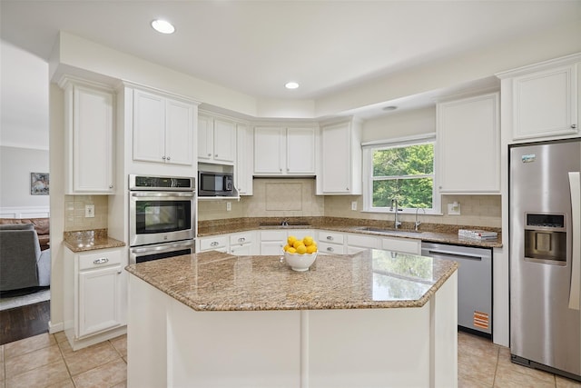 64 Lambert Rdg, Cross River, NY 10518 - kitchen featuring appliances with stainless steel finishes, light tile patterned floors, white cabinetry, light stone counters, and recessed lighting
