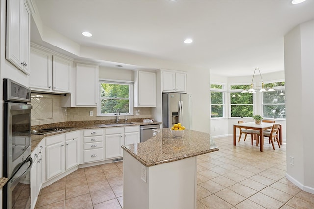 64 Lambert Rdg, Cross River, NY 10518 - kitchen featuring appliances with stainless steel finishes, a center island, light tile patterned floors, backsplash, and recessed lighting