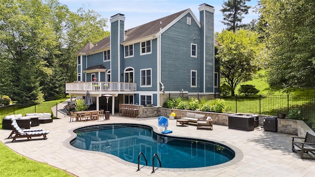 64 Lambert Rdg, Cross River, NY 10518 - rear view of house featuring outdoor lounge area, a chimney, a patio area, and a balcony