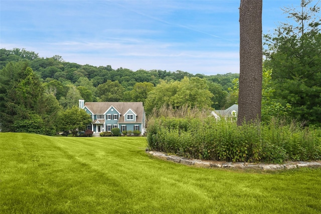 64 Lambert Rdg, Cross River, NY 10518 - view of front of home with a front lawn and a wooded view