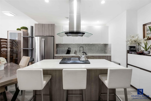 2222 Ocean Ave Ph-B, Ph-B Brooklyn, NY 11229 - kitchen with stainless steel appliances, island range hood, modern cabinets, light countertops, and a kitchen breakfast bar
