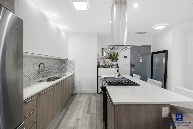 2222 Ocean Ave Ph-B, Ph-B Brooklyn, NY 11229 - kitchen featuring appliances with stainless steel finishes, modern cabinets, light countertops, island exhaust hood, and a kitchen island