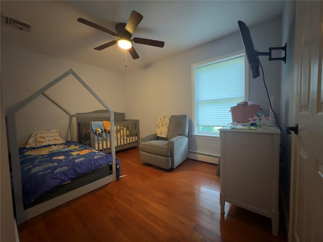 5 Sabrina Ln, Ossining, NY 10562 - bedroom featuring wood finished floors, a baseboard radiator, and a ceiling fan