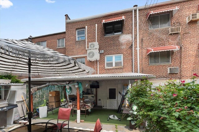 710 E 213th St, Bronx, NY 10467 - rear view of house with brick siding and a patio area