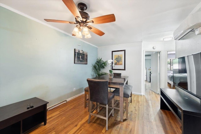 710 E 213th St, Bronx, NY 10467 - dining area featuring ornamental molding, a ceiling fan, light wood-type flooring, and a wall mounted AC