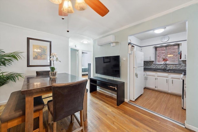 710 E 213th St, Bronx, NY 10467 - dining room with a wall mounted air conditioner, light wood-style flooring, crown molding, and a ceiling fan