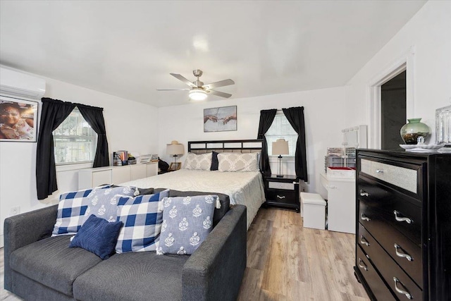710 E 213th St, Bronx, NY 10467 - bedroom with light wood-type flooring, a wall mounted air conditioner, and a ceiling fan