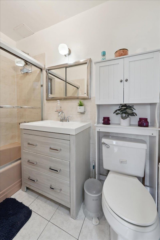710 E 213th St, Bronx, NY 10467 - bathroom featuring vanity, shower / bath combination with glass door, tile patterned flooring, and tile walls