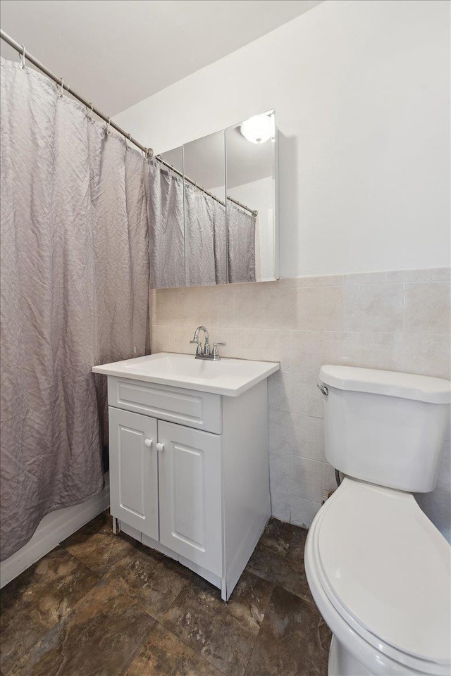 710 E 213th St, Bronx, NY 10467 - bathroom featuring vanity, stone finish floors, tile walls, and a shower with curtain