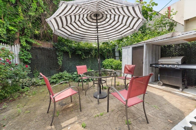 710 E 213th St, Bronx, NY 10467 - view of patio / terrace with a grill, outdoor dining space, and a shed