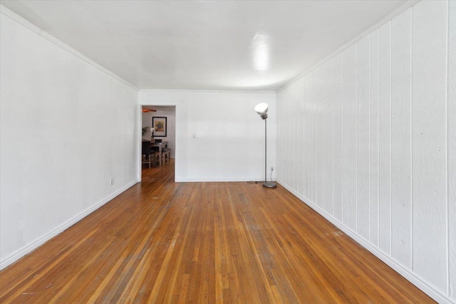710 E 213th St, Bronx, NY 10467 - spare room featuring hardwood / wood-style floors and crown molding