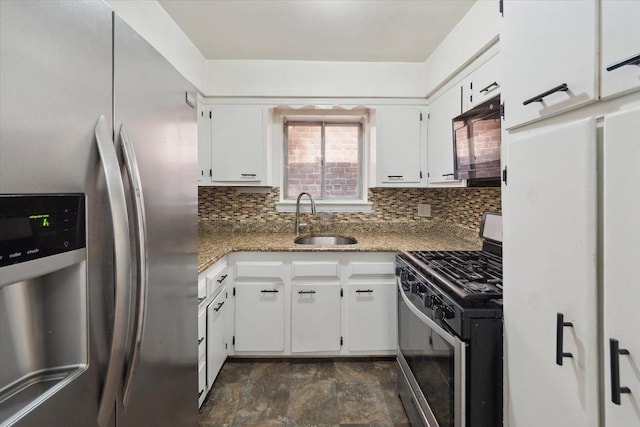 710 E 213th St, Bronx, NY 10467 - kitchen with appliances with stainless steel finishes, tasteful backsplash, white cabinets, and stone finish flooring